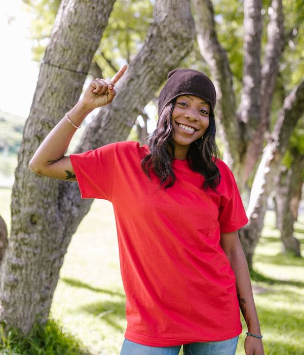 Woman feeling energetic and vibrant in a natural setting.